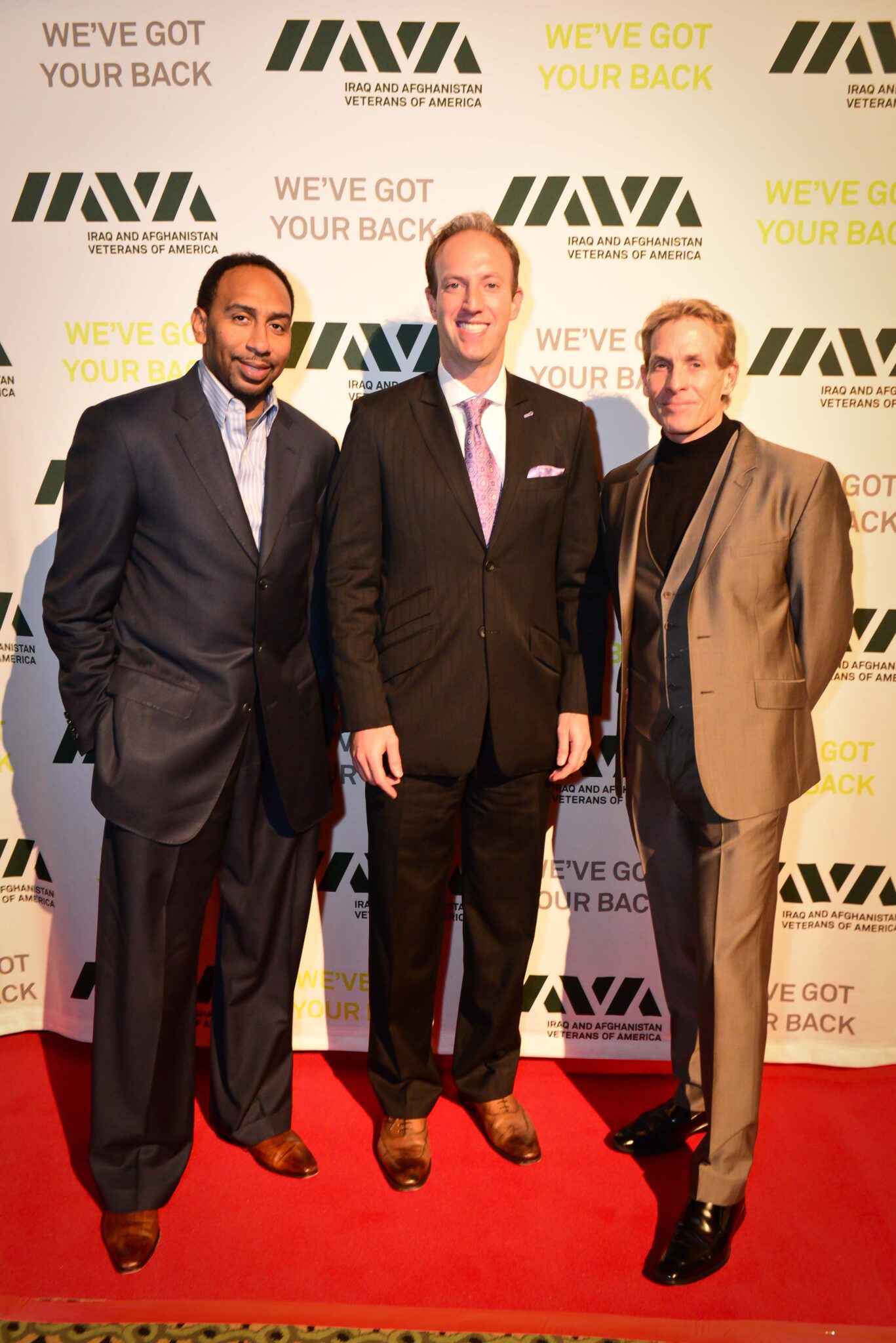 Jamie Horowitz posing with sports commentators Stephen A. Smith and Skip Bayless at an IAVA (Iraq and Afghanistan Veterans of America) event.